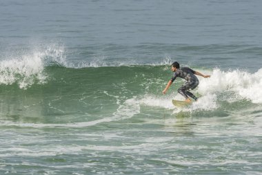 Man surfing in Barra da Tijuca beach clipart