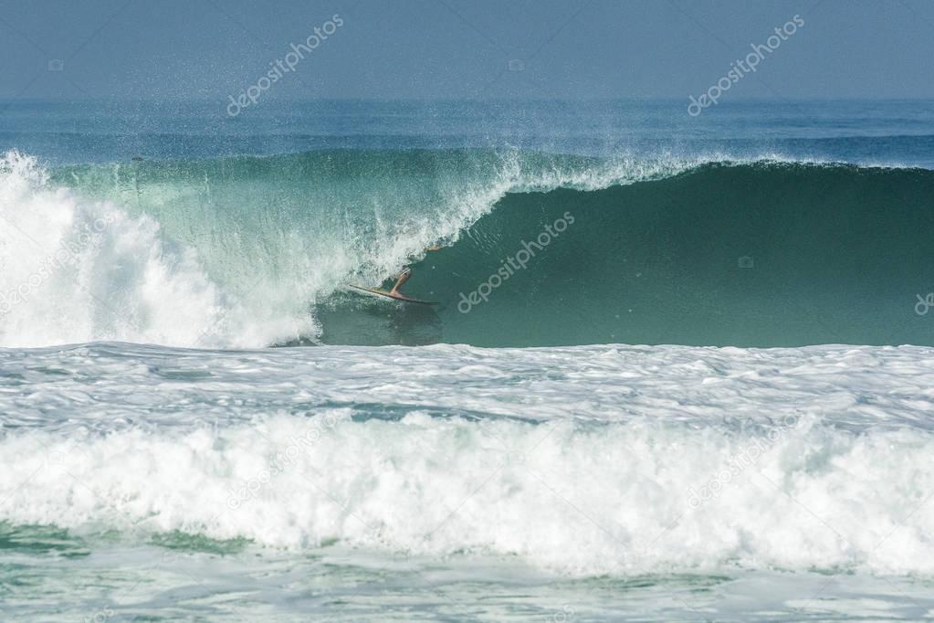 Surfing inside the barrel in Barra da Tijuca Beach