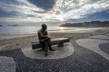 Statue of Carlos Drummond de Andrade, Brazilian poet seen during sunrise in Copacabana Beach, Rio de Janeiro, Brazil clipart
