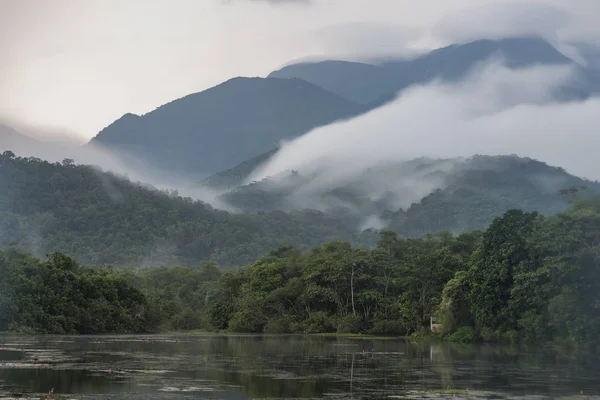 Clouds rolling down the mountains on a misty weather in the Atlantic Rainforest near Guapiacu, countryside of Rio de Janeiro, Brazil