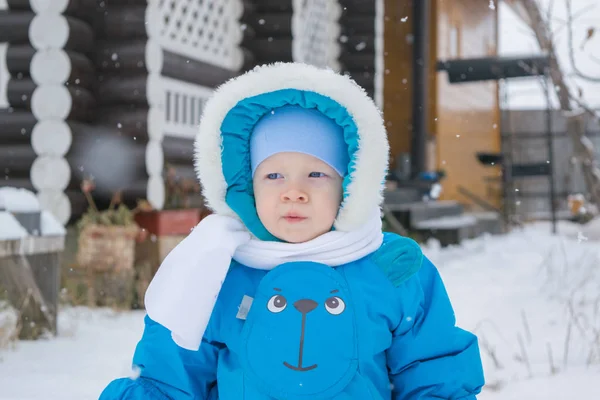Baby boy walking at a snow yard - winter outing