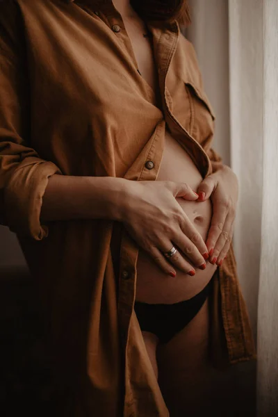 Pregnant women staying at windows