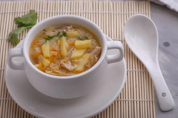 Soup with chicken, carrots, potatoes and pasta in the form of stars.