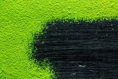green matcha tea powder on black background clipart