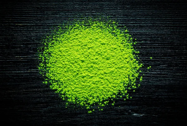 Green matcha tea powder on black background — Stock Photo, Image