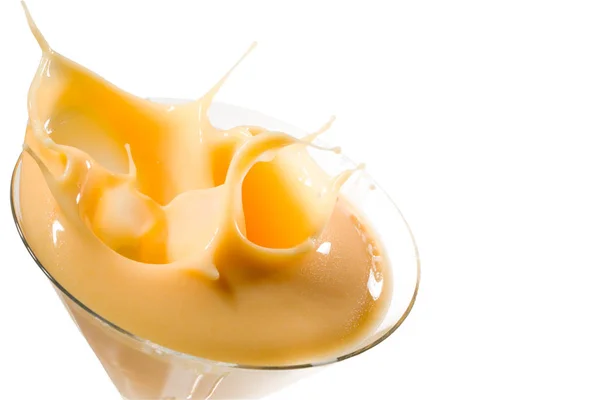 Egg liqueur splashing in glass, isolated on white background, cl — Stock Photo, Image
