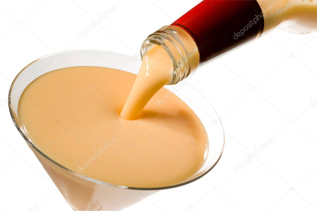 egg liqueur pour out in glass, isolated on white, clipping path 