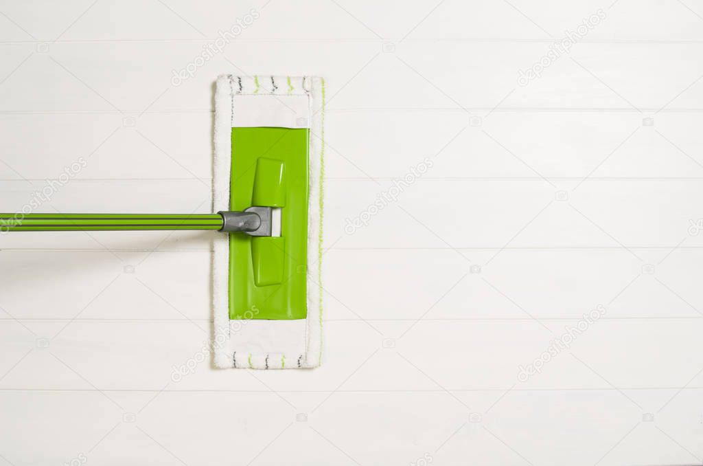 Cleaning floor with mop top view on white wooden background