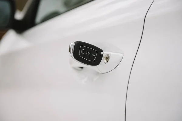 Car keys in white door lock closeup with copy space — Stock Photo, Image