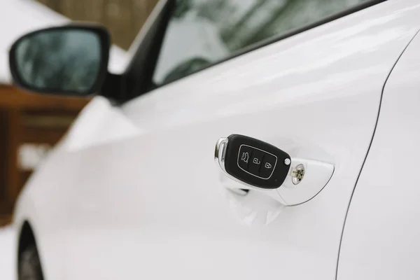 Car keys in white door lock closeup with copy space — Stock Photo, Image