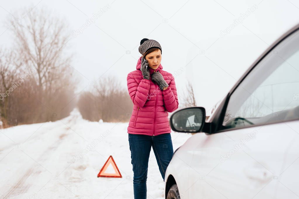 Woman calling for help or assistance - winter car breakdown