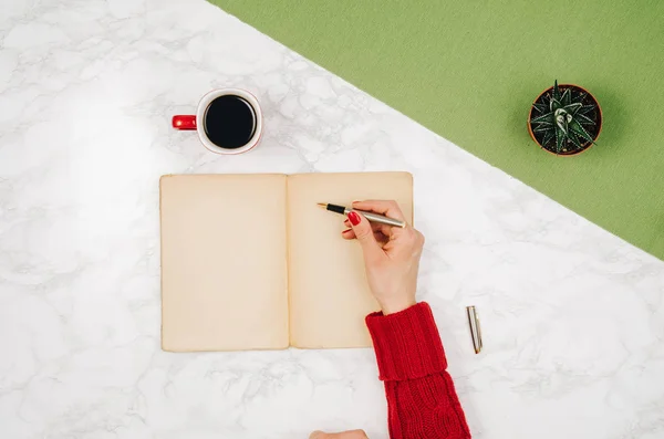 Handwriting in blank notebook on white marble table background — Stock Photo, Image