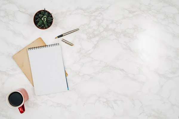 Blank notebook page on white marble table background — Stock Photo, Image