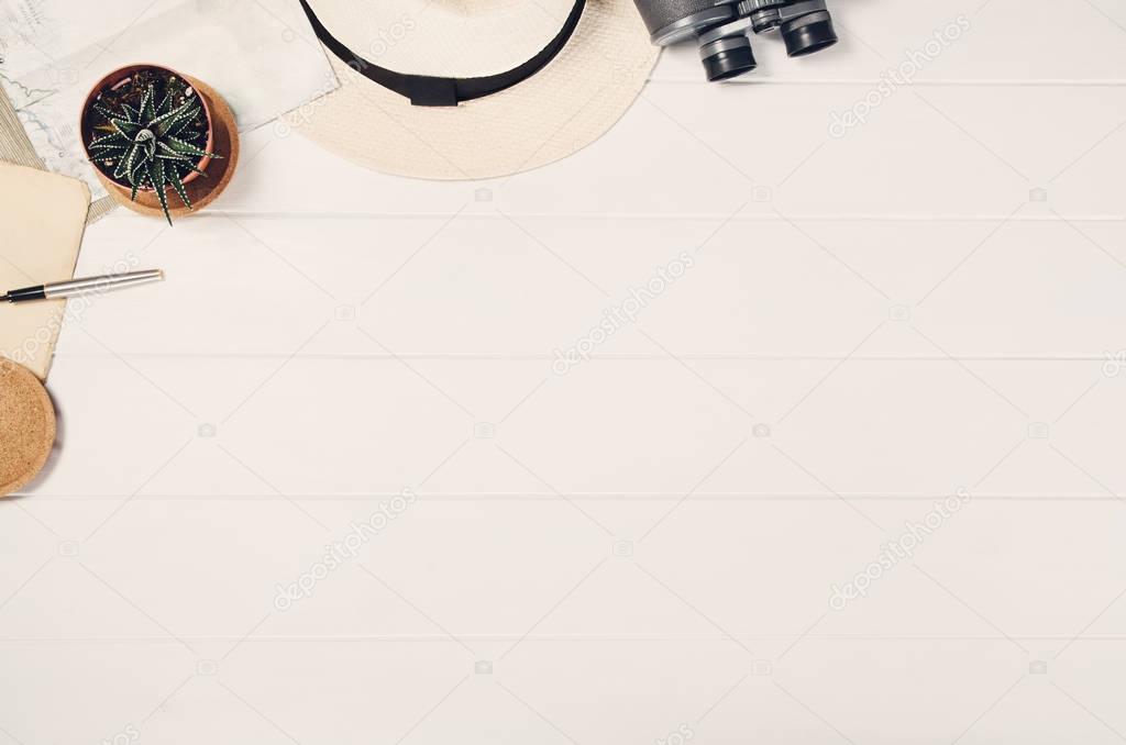 Accessories for travel top view on white wooden background frame