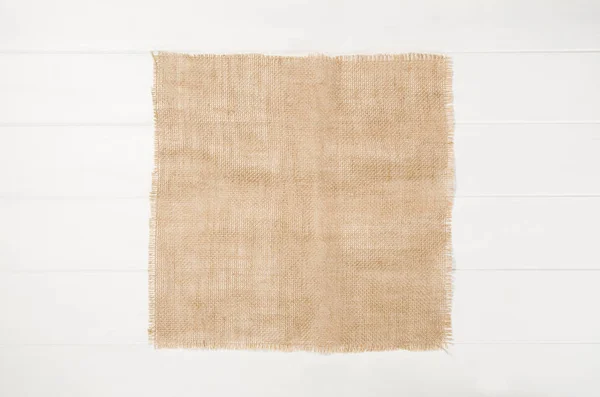 Fehér, fából készült padló textúra juta ruhával háttérrel — Stock Fotó