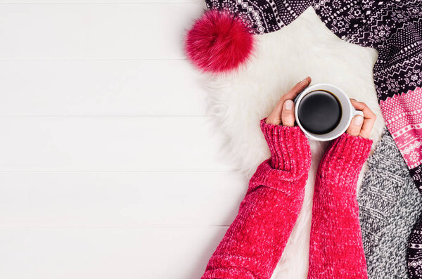 Hand holding cup of coffee. Top view with copy space