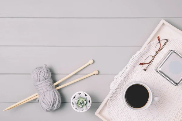 Fondo de punto con lana y agujas sobre mesa de madera gris — Foto de Stock