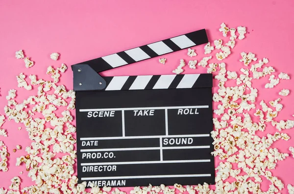 Popcorn, movie clip on pink background top view, copy space