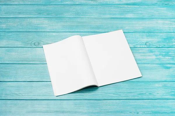 Mock-up magazine, newspaper or catalog on blue background. Blank page