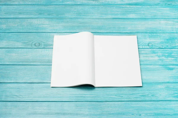 Mock-up magazine, newspaper or catalog on blue background. Blank page