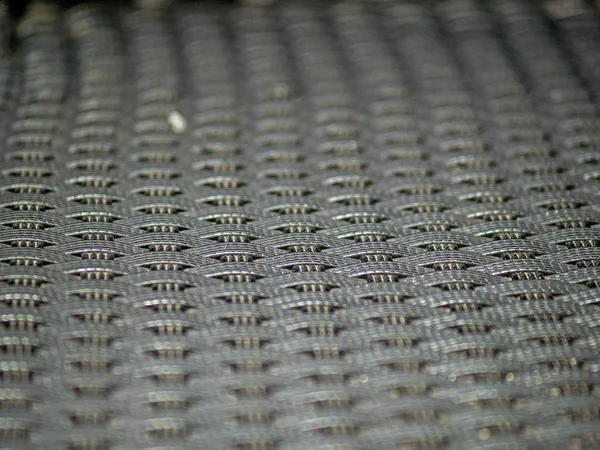 Schwarze Textur eines geflochtenen Stuhls — Stockfoto