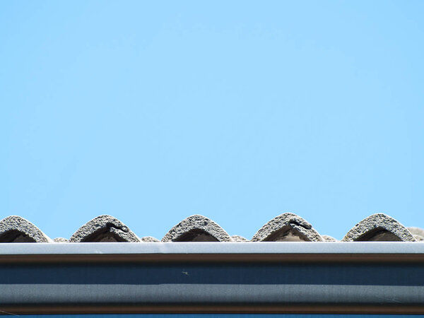 View of the tiles of a roof on a house
