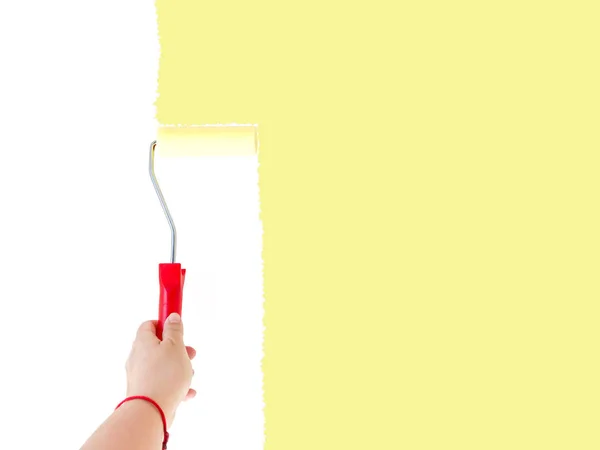 One person painting a white wall with a roller brush — Stock Photo, Image