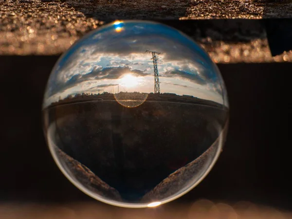 Reflections of the sunset in the city in a crystal ball / environment concept — Stock Photo, Image