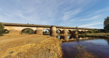 Roman Bridge with reflections in Tinto River, Niebla clipart
