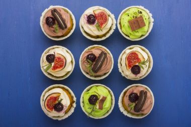 Cupcakes karanlık, ahşap arka plan üzerinde bir dizi.