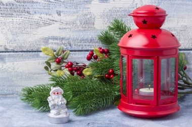 Kırmızı mum içinde bir mum ve bir Noel ağacı dalı. Noel ve yeni yıl Tema