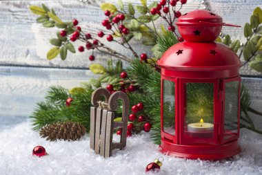 Bir mum içinde kırmızı bir şamdan ile yılbaşı oyuncakları. Noel Baba'nın kızağı. Noel tatili 