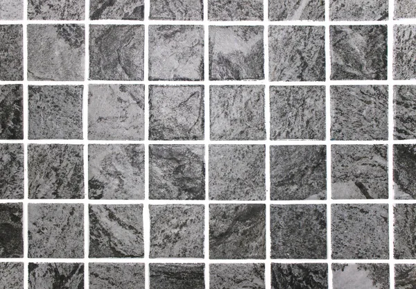 Gray square ceramic tiles, background, texture. A rock