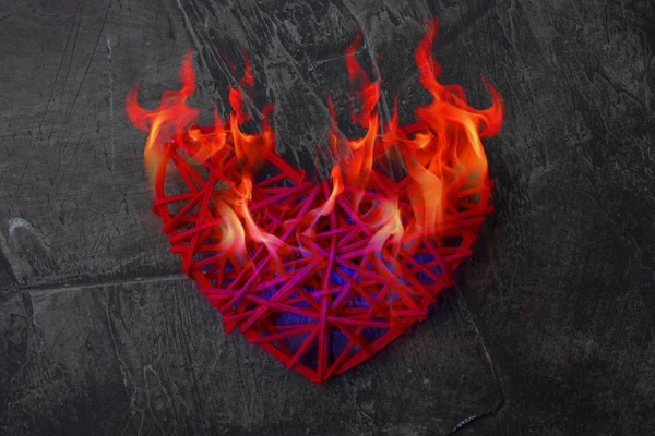 The cold heart melts from the flame of fire. The heart is on fire. Theme for Valentine\'s Day. Wedding, love 1