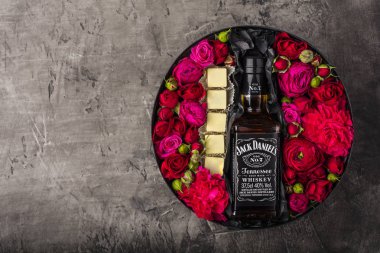 Novosibirsk, Rusya Federasyonu - 23 Şubat 2018 - hediye paketleri Jackdaniels viski. Belçika beyaz çikolata küpleri. Çiçekler ve alkol
