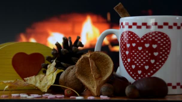 Cup of hot drink near the fireplace — Stock Video