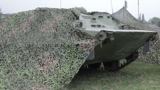 Infantry combat vehicle covered with camouflage nets — Stock Video