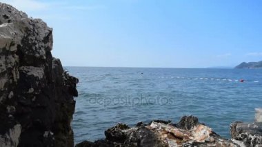 kayaların üzerinde kıyıya ve mavi denizin şamandıralar