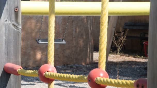 Empty swing in the backyard of kindergarten — Stock Video