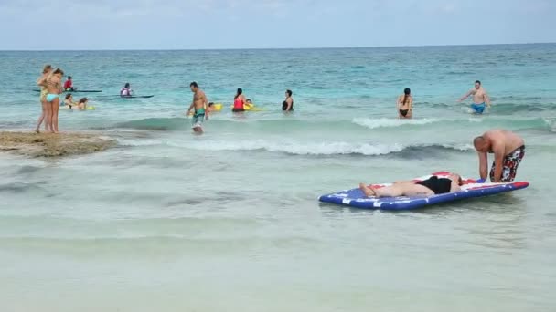 2 em 1, os turistas estão desfrutando nas ondas na praia — Vídeo de Stock