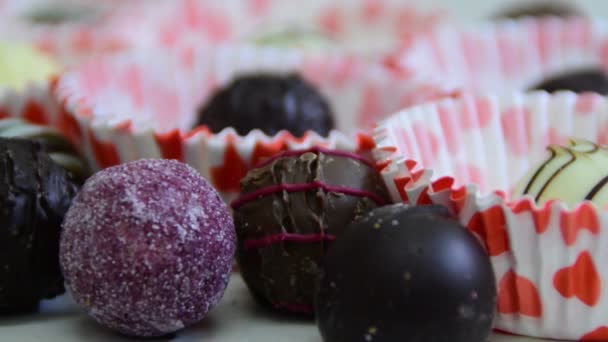 Chocolate balls, woman's hand taking candy — Stock Video