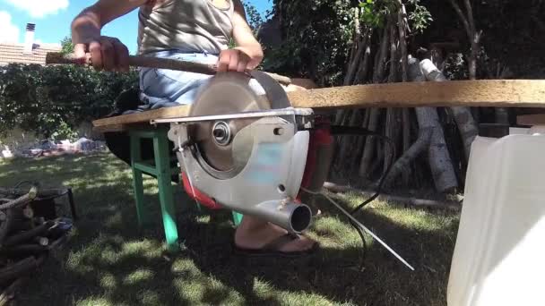 Man cutting wood, branches, making them firewood — Stock Video