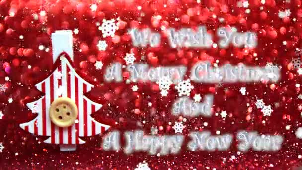 我们祝愿您一个愉快的圣诞节和新年快乐文本 装饰红色和白色圣诞树和下落的雪的作用 — 图库视频影像