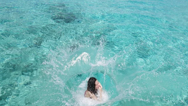 Girl jumped into the water holding her nose -  Cozumel, Mexico