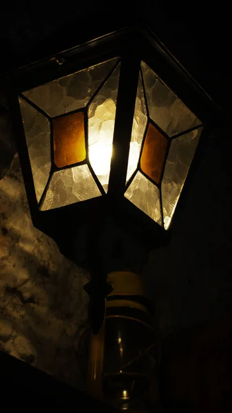 Decorative lamp on a old wall at night.