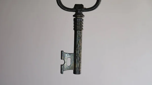Corkscrew for opening bottles in the form of a key. Old decoration key. Vintage metal key. Old rusty ancient key. Negative space.