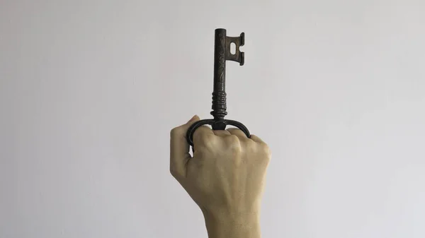 Corkscrew for opening bottles in the form of a key in a woman\'s fist.