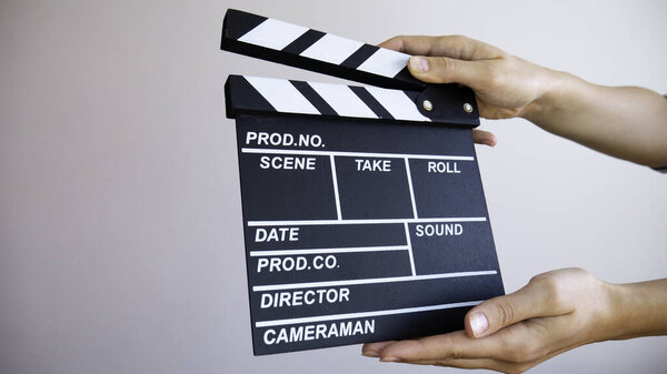 Close up clapperboard in hands. Cinematography production concept. 