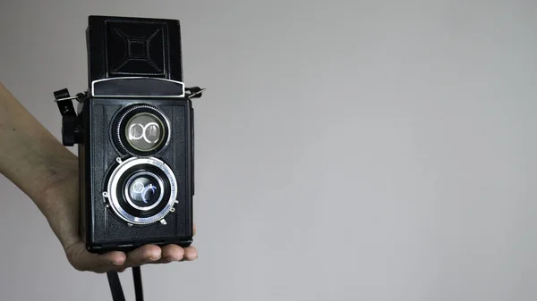 Vintage two lens photo camera isolated on white background. Negative space.