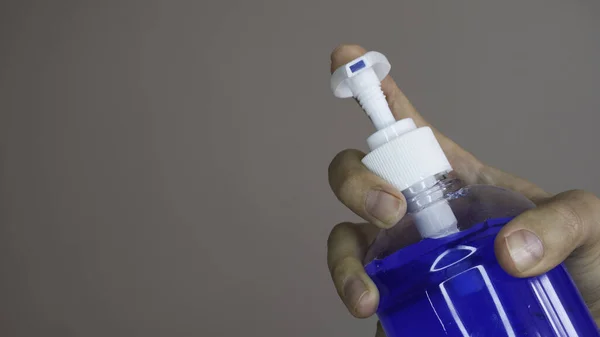 Woman Hand Holding Bottle Blue Alcohol Gel Negative Space Copy — Stock Photo, Image